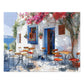 Idyllic Café Charm Watercolor Puzzle: Coastal Scene with Blossoms, Shipped in a Metal Box