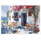 Idyllic Café Charm Watercolor Puzzle: Coastal Scene with Blossoms, Shipped in a Metal Box